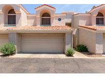 Inviting home exterior featuring a two-car garage, desert landscaping, and a unique tile roof at 7716 S Rita Ln, Tempe, AZ 85284