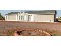 Charming single-story home with gravel landscaping and covered porch for relaxed, inviting curb appeal at 10618 W Prairie Ln, Casa Grande, AZ 85193