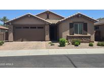Charming single-story home featuring a well-manicured front yard and a two-car garage at 120 E Horseshoe Dr, Chandler, AZ 85249