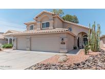 Charming two-story home with a three car garage, desert landscaping, and a tile roof at 12042 S 44Th St, Phoenix, AZ 85044
