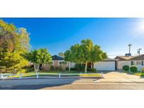 Charming single-story home featuring a well-manicured lawn, mature trees, and a cozy, inviting exterior at 12431 N 30Th Ave, Phoenix, AZ 85029