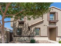 Inviting two-story home with a well-maintained exterior and desert landscaping at 1255 S Rialto -- # 115, Mesa, AZ 85209
