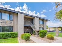 Charming condo featuring stone accents, a cozy entryway, and well-maintained landscaping at 1402 E Guadalupe Rd # 207, Tempe, AZ 85283