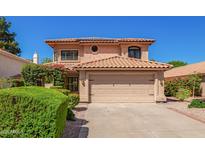 Charming two-story home with a terra cotta roof, flowering bushes, and a two car garage at 1575 S Pennington Dr, Chandler, AZ 85286