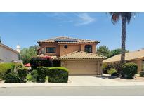 Charming two-story home featuring a desert landscape, a tile roof, a two-car garage and solar panels at 1575 S Pennington Dr, Chandler, AZ 85286
