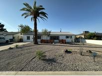 Charming single-story home with desert landscaping and a mature palm tree in the front yard at 1930 W Missouri Ave, Phoenix, AZ 85015