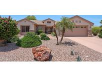 Charming single-story home with landscaped front yard and stone accents at 19662 N Overton Ct, Surprise, AZ 85374