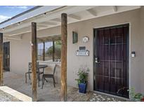 Inviting front porch with flagstone flooring and outdoor seating area by the secure entrance at 3018 E Mulberry Dr, Phoenix, AZ 85016