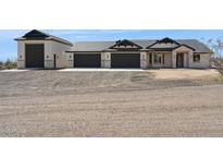 Beautiful single Gathering home featuring a neutral color scheme, three-car garage, and desert landscaping at 31652 N Misty Ln, Queen Creek, AZ 85142