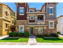 Charming multi-story townhome with stone accents, neat landscaping, and a welcoming front entrance at 4072 E Windsor Dr, Gilbert, AZ 85296