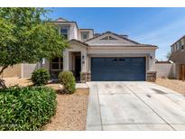 Charming single-Gathering home featuring stucco siding, a two-car garage, and neatly landscaped front yard at 42098 W Balsa Dr, Maricopa, AZ 85138