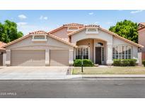 Inviting single-story home showcasing a desert landscape, a two-car garage and beautiful architectural details at 4684 W Tyson St, Chandler, AZ 85226