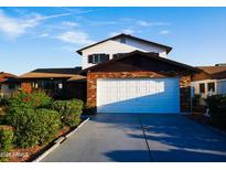 Charming two-story home featuring a brick facade and well-maintained landscaping at 5761 W Cholla St, Glendale, AZ 85304