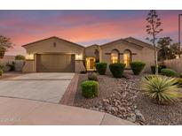 Charming single-story home featuring a well-manicured yard, desert landscaping, and a welcoming entrance with a gated courtyard at 6648 S Lyon Dr, Gilbert, AZ 85298