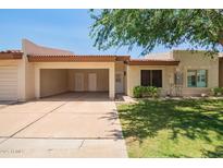 Charming single-story home featuring an open carport and well-maintained front yard landscaping at 9106 N 68Th Ln, Peoria, AZ 85345