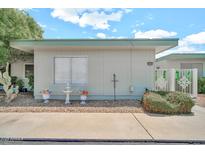 Charming single-story home with white exterior, front yard decor, and well-maintained landscaping at 13207 N 98Th Ave # L, Sun City, AZ 85351