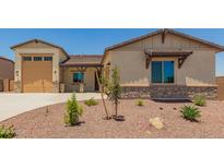 Inviting single-Gathering home features a desert landscape, neutral colors, a two car garage, and stone accents at 17304 W Royal Palm Rd, Waddell, AZ 85355