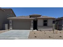 Charming single-story home showcasing a tile roof and a two-car garage at 18354 W Patrick Ln, Surprise, AZ 85387