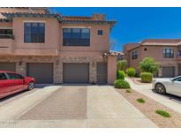 Beautiful townhome with a two-car garage, stone accents, and well-maintained landscaping at 20660 N 40Th St # 2124, Phoenix, AZ 85050