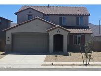 Charming two-story home featuring a two-car garage and well-maintained landscaping at 22655 W Mohawk Ln, Surprise, AZ 85387