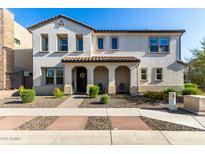 Charming two-story home with a covered front porch and desert landscaping at 2371 W Whisper Rock Trl, Phoenix, AZ 85085
