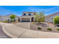 Inviting two-story home with a two-car garage and low-maintenance desert landscaping in front at 24533 N 19Th Ter, Phoenix, AZ 85024