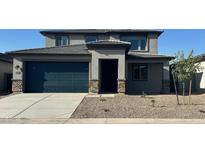 Charming two-story home with a two-car garage and well-maintained front yard with desert landscaping at 25360 W Bowker St, Buckeye, AZ 85326