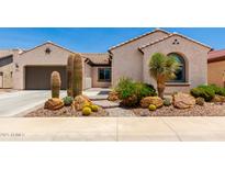 Charming home featuring desert landscaping with cacti and rock features at 26161 W Siesta Ln, Buckeye, AZ 85396