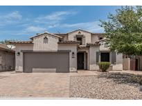 Charming two-story home boasts a tile roof, two-car garage, and desert landscaping at 28263 N Welton Pl, San Tan Valley, AZ 85143