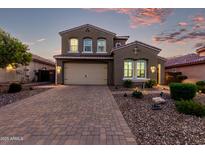 Charming two-story home boasts a well-manicured lawn and a spacious two car garage at 32096 N 132Nd Dr, Peoria, AZ 85383