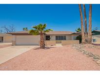 Charming single-story home featuring mature palm trees, low brick facade, and a two car garage at 3620 S Terrace Rd, Tempe, AZ 85282
