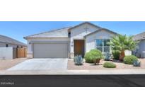 Charming single-story home showcasing a well-manicured front yard, a two-car garage, and desert landscaping at 38144 W San Clemente St, Maricopa, AZ 85138