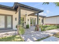 Charming home featuring a covered front entrance with a brick walkway and manicured landscaping at 3924 E Roma Ave, Phoenix, AZ 85018