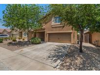 Charming two-story home with a well-manicured front yard and a two-car garage at 4380 W White Canyon Rd, San Tan Valley, AZ 85144