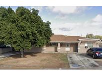 Charming single-story home with well-maintained lawn and mature trees offering curb appeal at 608 W 2Nd Pl, Mesa, AZ 85201