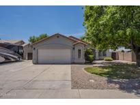 Charming single-story home featuring a spacious two-car garage and a well-maintained front yard with mature landscaping at 807 E San Remo Ave, Gilbert, AZ 85234