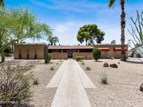 Charming single story home with desert landscaping and block wall in a sunny neighborhood at 1 W Canterbury Ln, Phoenix, AZ 85023