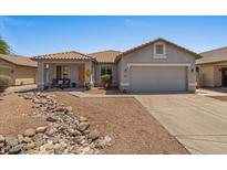 Charming single-story home with a well-maintained lawn and a two-car garage at 10235 E Jerome Ave, Mesa, AZ 85209