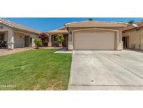 Charming single-story home with a well-manicured lawn, a two-car garage, and inviting curb appeal at 11206 W Coronado Rd, Avondale, AZ 85392