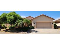 Charming single-story home featuring a two-car garage and meticulously landscaped front yard at 15728 W Verde Ln, Goodyear, AZ 85395