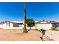 Modest single story home with a front yard and a desert landscape at 1602 N 73Rd Dr, Phoenix, AZ 85035