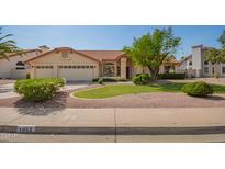 Charming home with a three-car garage, lush lawn, mature trees, and desert landscaping at 1956 E Calle De Caballos --, Tempe, AZ 85284
