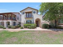 Charming two-story home featuring a well-manicured front yard and a welcoming entrance with an arched doorway at 20545 W Terrace Ln, Buckeye, AZ 85396