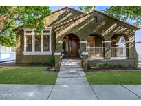 Charming home with arched porch, manicured lawn, and welcoming curb appeal at 2743 E Virginia St, Gilbert, AZ 85296