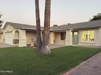 Charming single-story home with well-manicured lawn and inviting facade, complete with a two-car garage at 2753 E Aster Dr, Phoenix, AZ 85032