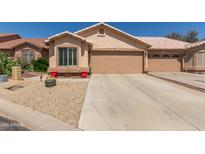 Inviting single-story home featuring a two-car garage and low-maintenance desert landscaping at 6610 E University Dr # 2, Mesa, AZ 85205