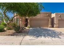 Charming single-story home featuring a two-car garage, desert landscaping, and a cozy front entrance at 8324 E Cactus Wren Rd, Scottsdale, AZ 85250