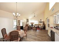 Bright living room features vaulted ceiling, hardwood floors, and stylish decor at 9235 N 101St St, Scottsdale, AZ 85258