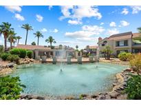Beautiful community pool area with fountains, palm trees, and well-maintained landscaping on a sunny day at 10115 E Mountain View Rd # 2061, Scottsdale, AZ 85258