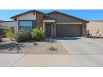 Charming single-story home featuring a two-car garage and low-maintenance desert landscaping at 10964 W Garfield St, Avondale, AZ 85323